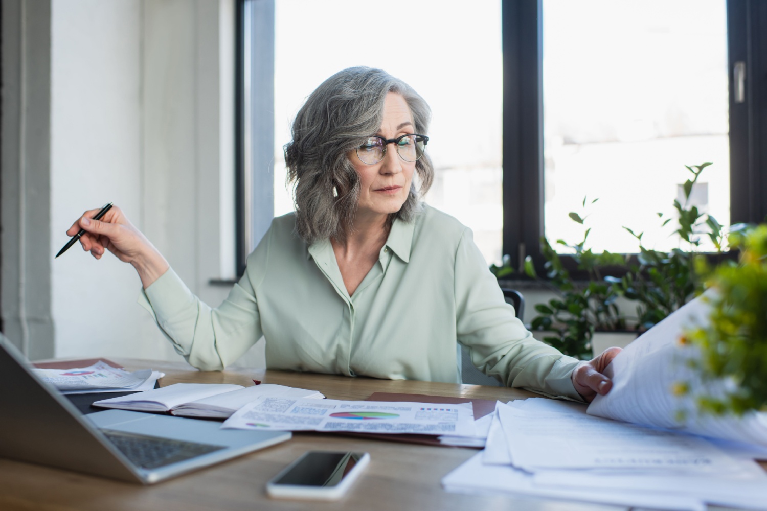 A woman searching through paperwork.